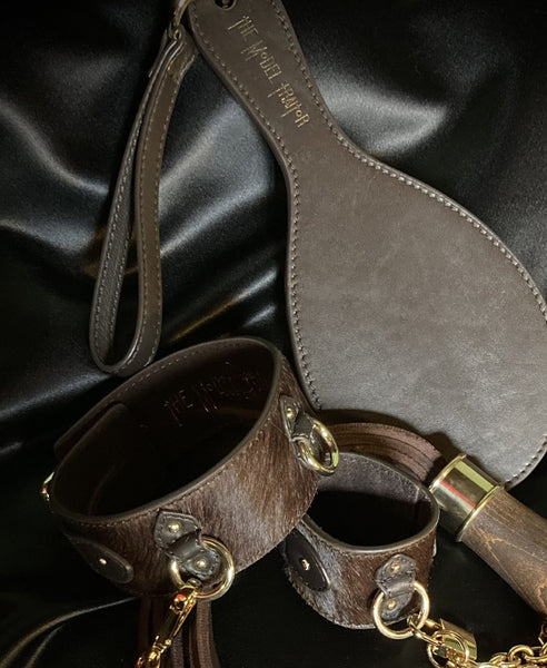 luxurious dark brown leather discipline paddle and restraints