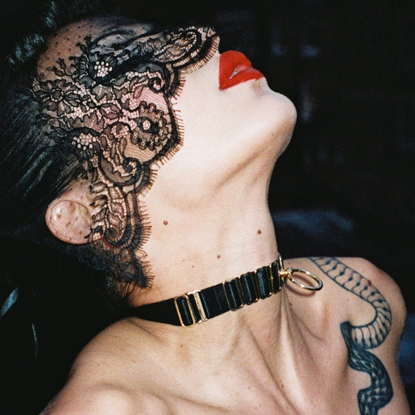 seductive femme fatale with red lipstick black choker with gold ring and lace veil